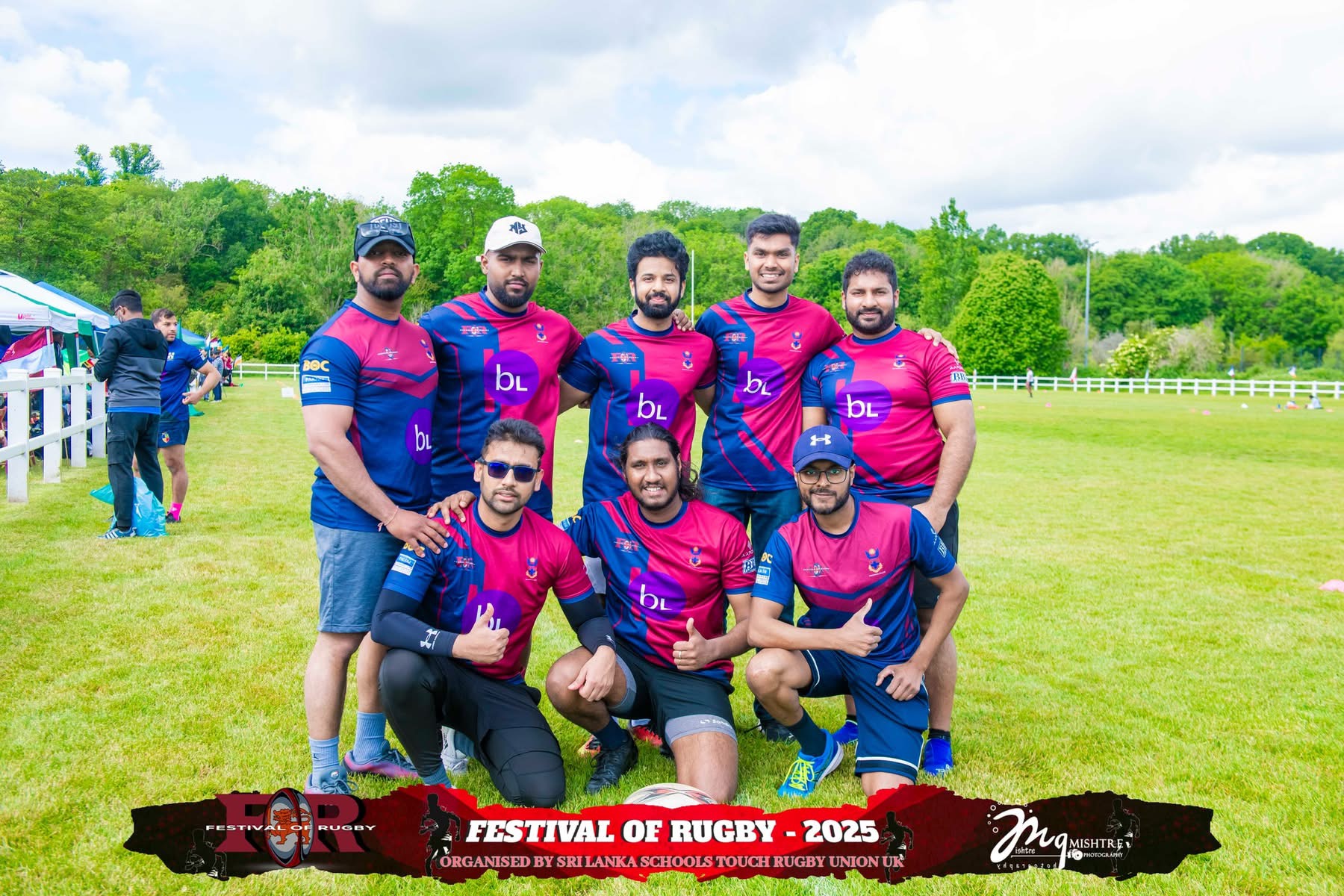 Men's rugby team in magenta jerseys posing on the pitch at Festival of Rugby 2025