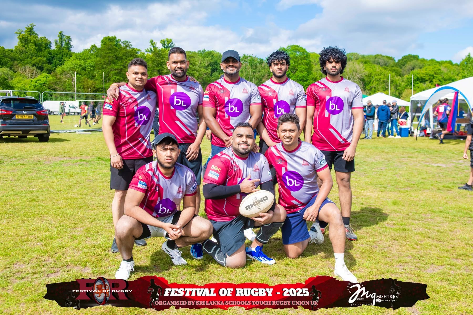 Men's rugby team in pink jerseys posing at Festival of Rugby 2025